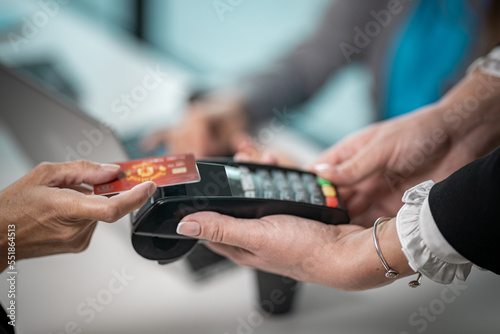 Close up on contactless paying terminal for credit cards, contactless paying Woman hand