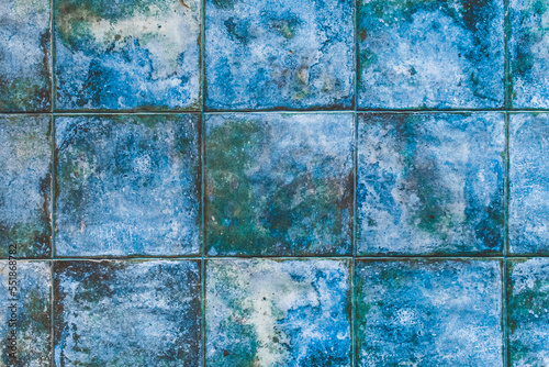Blue mosaic ceramic square tiles with abstract pattern texture background in modern interior