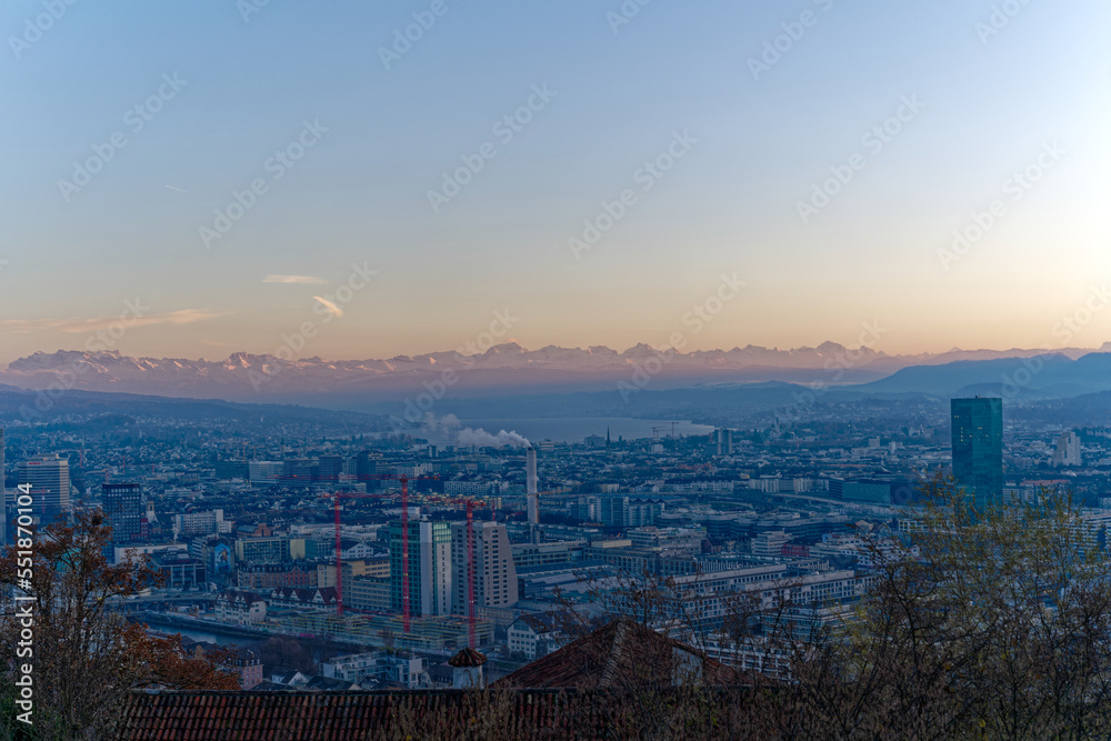 Aerial view over City of Zürich on a beautiful sunny autumn evening with lake and Swiss Alps in the background. Photo taken December 6th, 2022, Zurich, Switzerland.