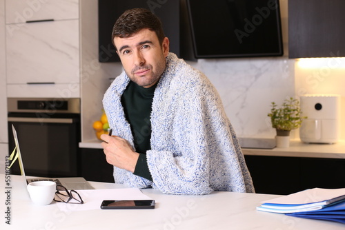 Man freezing while working in the kitchen  photo