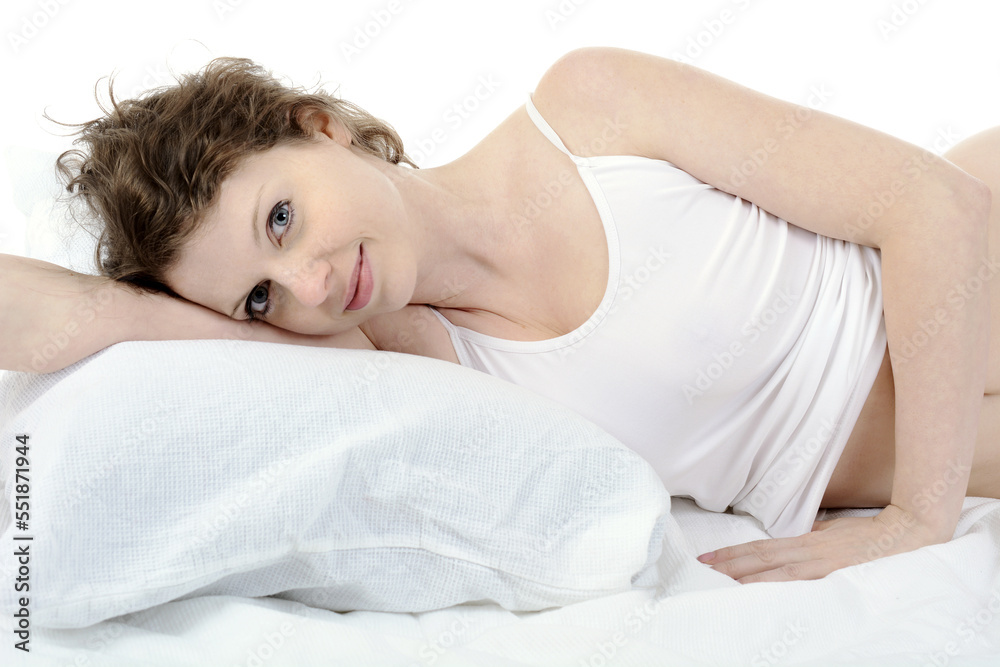 Beautiful young brunette woman lying relaxed in bed Beautiful young brunette woman lying relaxed in bed
