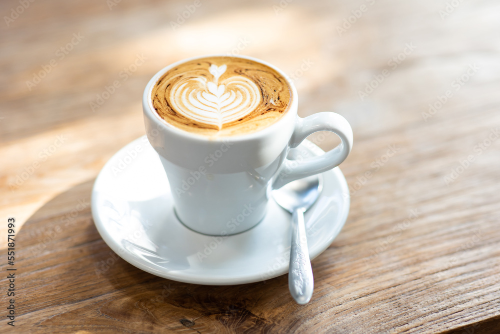 Cup of latte art or cappuccino with foam, coffee cup on table in cafe. Cup of latte art or cappuccino with foam, coffee cup on table in cafe.