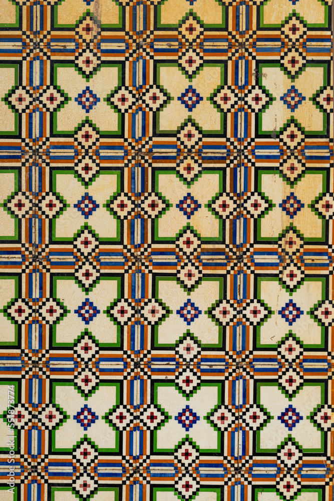 Fragment of building wall with floral ceramic wall tiles Azulejo Abstract decorative background textured ornate pattern. Traditional ornate Portuguese architecture