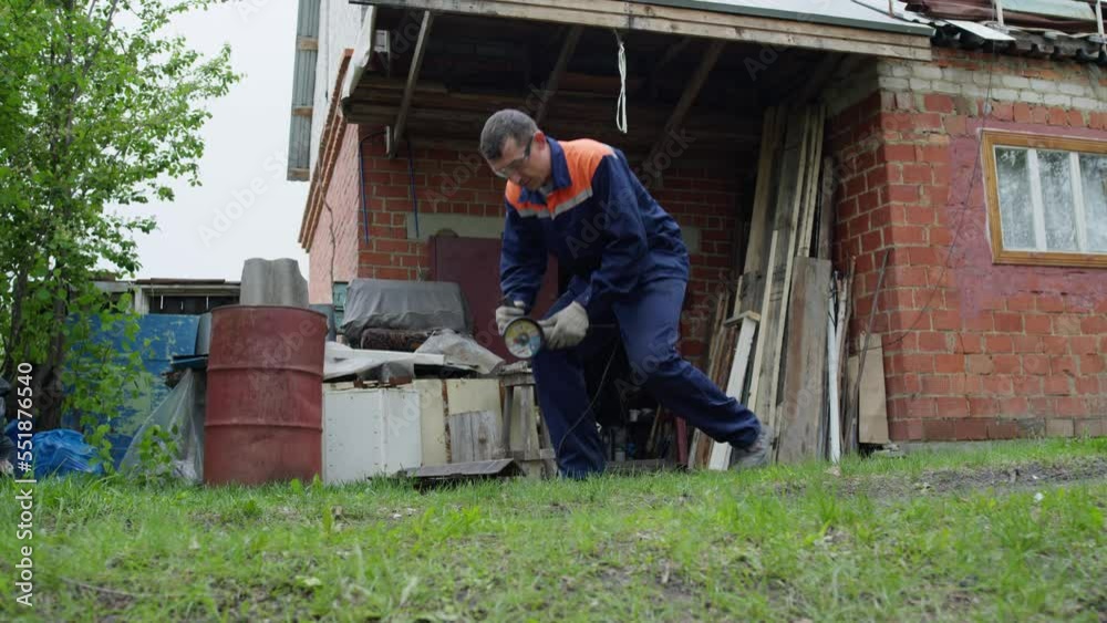 Man cutting metal with a tool