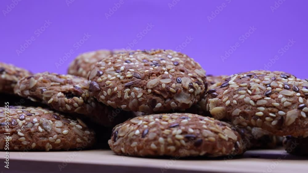 Freshly Baked Cookies Rotating On A Wooden Board On A Purple Background. 60 FPS, 4k, ProRes Freshly Baked Cookies Rotating On A Wooden Board On A Purple Background. 60 FPS, 4k, ProRes