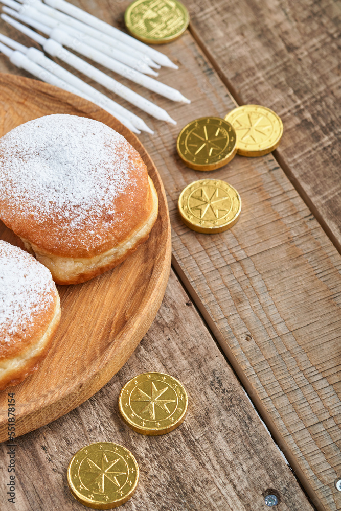 Happy Hanukkah. Hanukkah sweet doughnuts, gift boxes, white candles and chocolate coins on old wooden background. Image and concept of jewish holiday Hanukkah. Top view. Happy Hanukkah. Hanukkah sweet doughnuts, gift boxes, white candles and chocolate coins on old wooden background. Image and concept of jewish holiday Hanukkah. Top view.