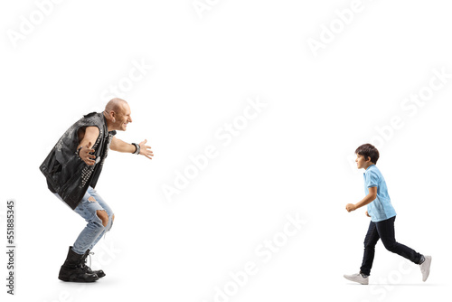 Full length profile shot of a child running to hug a punk