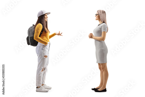 Full length profile shot of a female student talking to a young woman