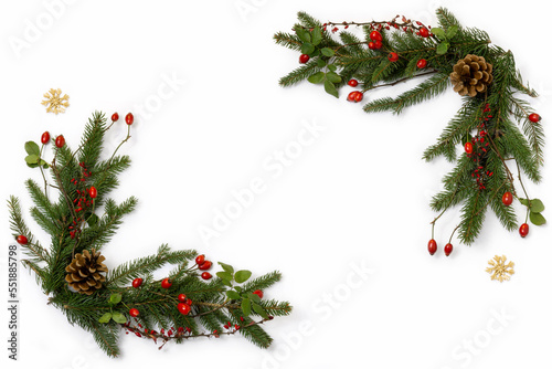 Background with natural floral christmas decoration - green spruce, barberry twigs and wild rose fruits with straw stars, copy space, flat lay
