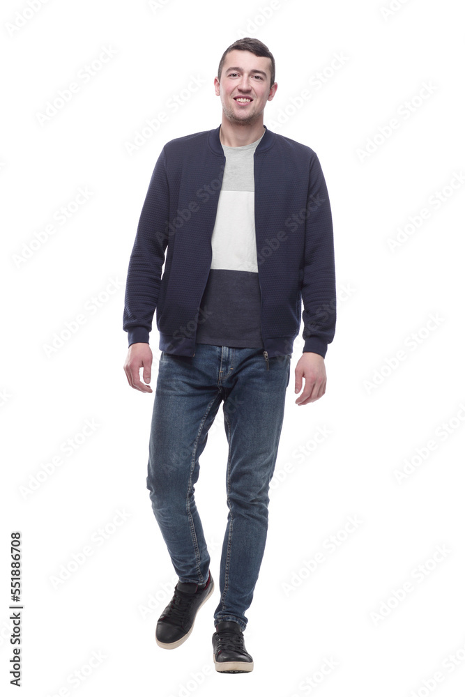 young man in jeans striding forward . isolated on a white young man in jeans striding forward . isolated on a white