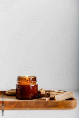 Merry Christmas decoration concept with burning candles and festive decor  christmas trees on light white background. Cozy home. Space for text.