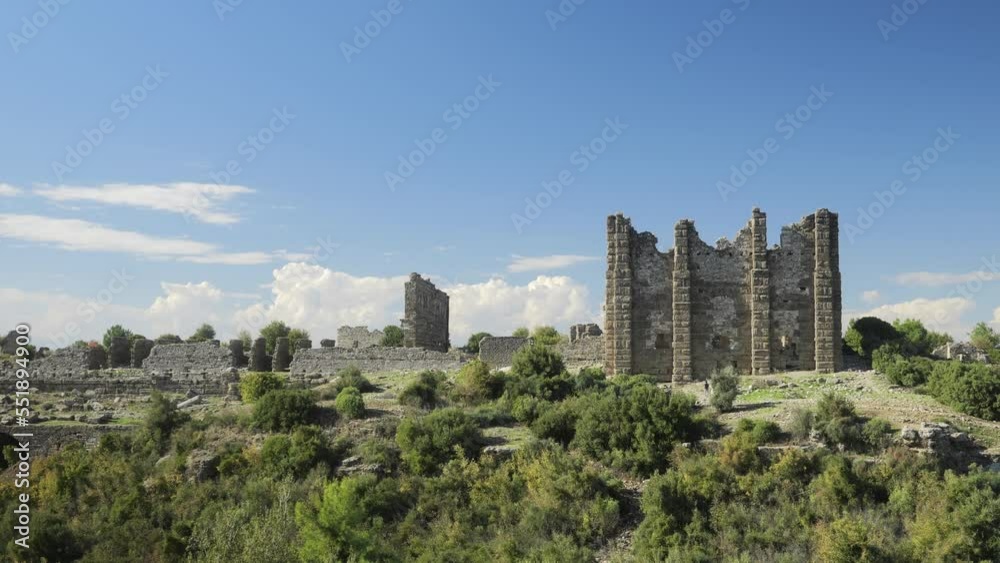 The remains of an ancient structure or castle or fortress in Antalya, Turkey. Beautiful cinematic shots of a ruined fortress on a sunny summer day. General view from afar. High quality 4k footage The remains of an ancient structure or castle or fortress in Antalya, Turkey. Beautiful cinematic shots of a ruined fortress on a sunny summer day. General view from afar. High quality 4k footage