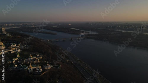 Kyiv, Ukraine - April, 2021: Morning aerial view on foggy city with traffic and bridge on Dniepro river 4k photo