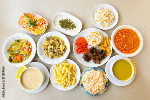 Traditional Turkish cuisine. Pizza, pita, pidesi, sucuk, hummus, kebab. Many dishes on the table. Serving dishes in restaurant. Background image. Top view, flat lay