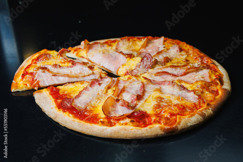 Delicious freshly baked pizza with tomato sauce and meat and cheese filling.