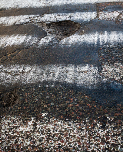 Pothole on the pedestrian crossing photo