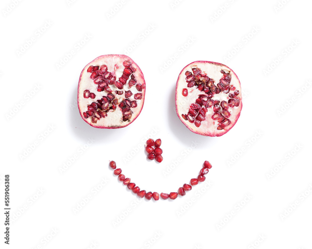 Sliced pomegranate and seeds in the form of a smile, isolated on white Sliced pomegranate and seeds in the form of a smile, isolated on white