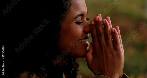 Person praying to God, African mixed race girl begging for divine help