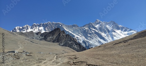 Beautiful high snow capped mountain peaks under blue sky in Chukhung at Mount Everest in Nepal photo