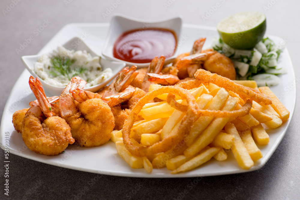 shrimps bani or fried shrimp with fries and tomato sauce served in dish isolated on grey background top view of arabic food shrimps bani or fried shrimp with fries and tomato sauce served in dish isolated on grey background top view of arabic food