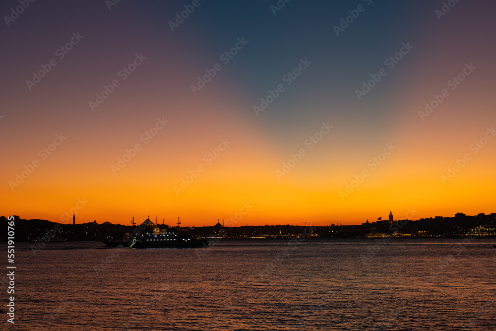 Istanbul skyline with crepuscular rays at sunset.