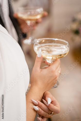 bride or girl in a white dress holding a glass of champagne