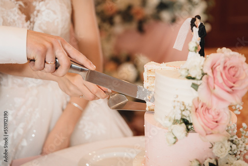 bride and groom cut cake in powder colors