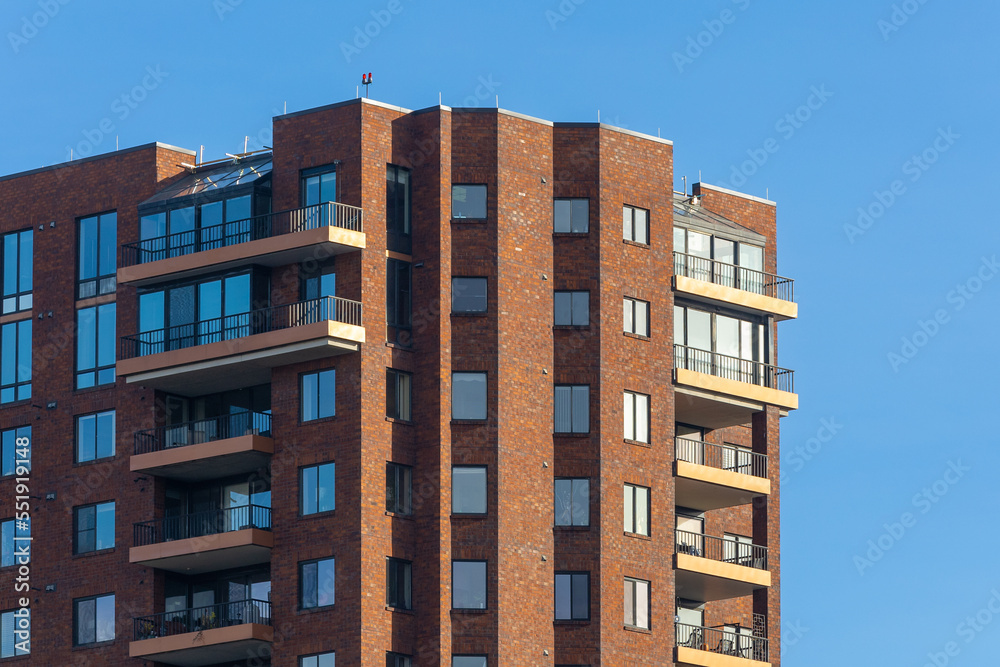Brick exterior luxury apartment building with balconies, new construction, with blue sky, downtown Columbus Ohio