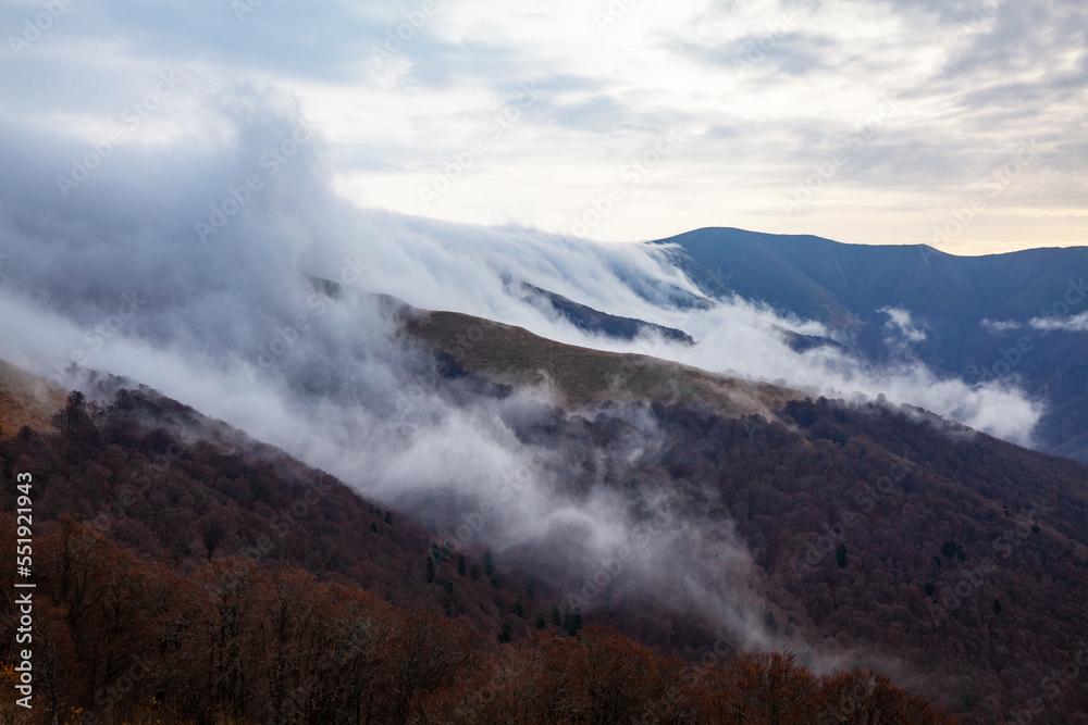 Amazing mountain autumn landscape with low clouds