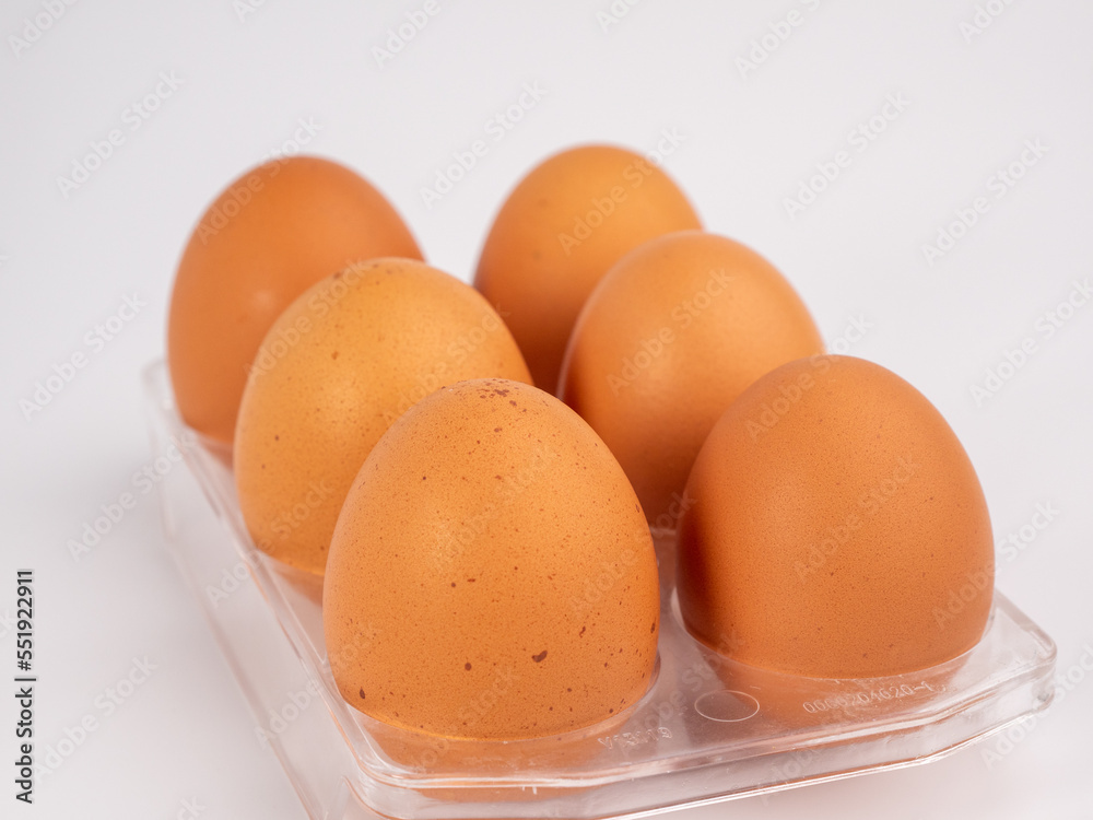 Chicken eggs on a white background. Brown egg on a white background. Chicken eggs on a white background. Brown egg on a white background.