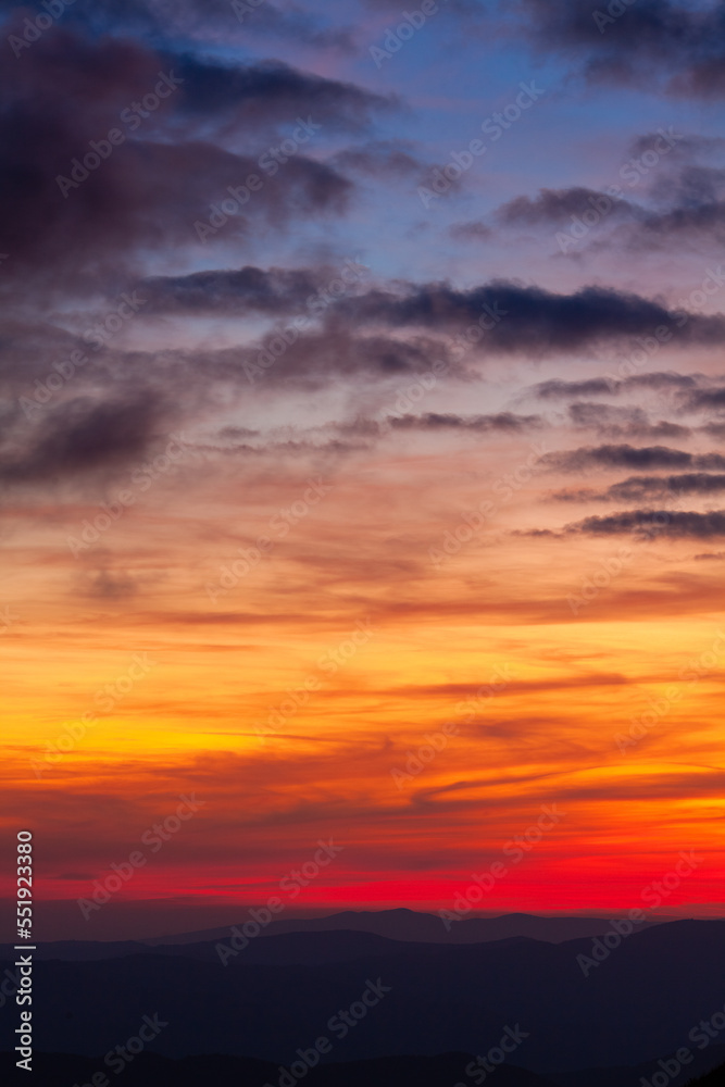 Multicolored sky gradient with clouds