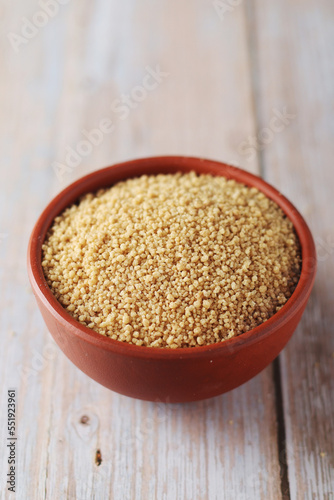 Dry couscous in a small ceramic bowl
