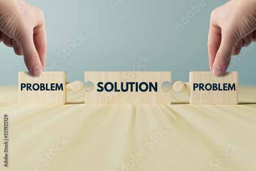 The hand holds wooden blocks, a puzzle with the inscription problem and solution. The concept of problem solving, dealing with difficulties. Help in difficulties.