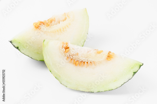 Slices of green melon on light background