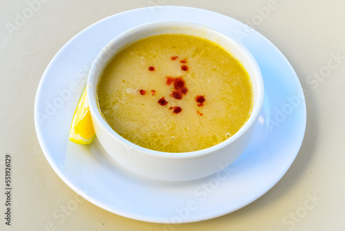 Lentil ( mercimek ) soup with melted butter and red pepper sauce. Mercimek corbasi