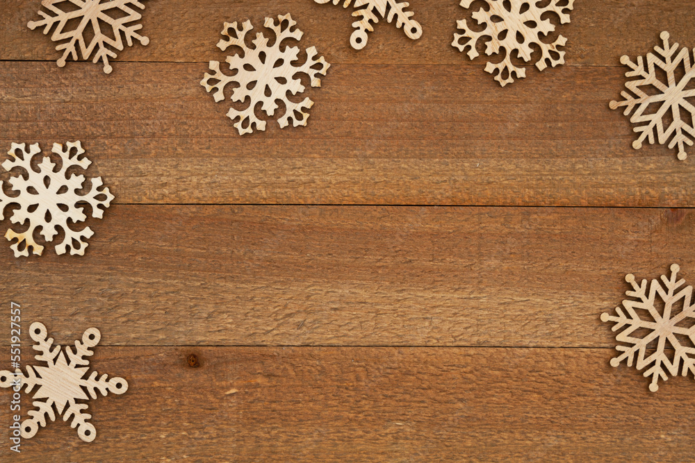 Wood snowflakes on weathered wood holiday background Wood snowflakes on weathered wood holiday background