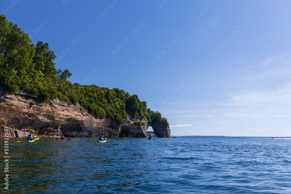 Boats and kayakers at Lover's Leap rock arch in Lake Superior at Pictured Rocks National Lakeshore, Upper Peninsula, Michigan, USA Boats and kayakers at Lover's Leap rock arch in Lake Superior at Pictured Rocks National Lakeshore, Upper Peninsula, Michigan, USA