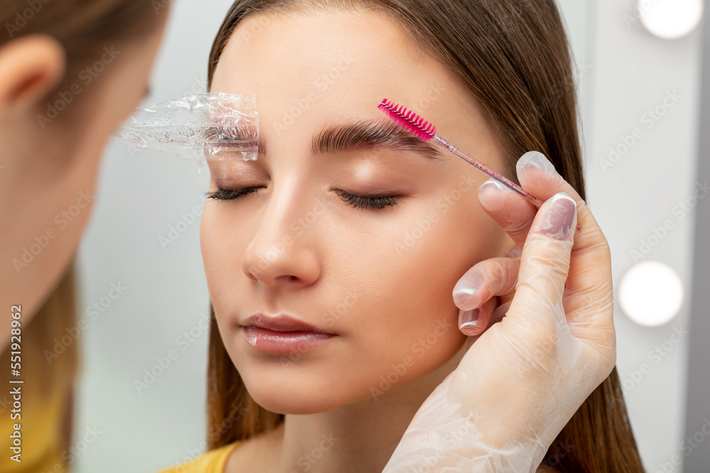 The make-up artist does Long-lasting styling of the eyebrows of the eyebrows and will color the eyebrows. Eyebrow lamination. Professional make-up and face care. The make-up artist does Long-lasting styling of the eyebrows of the eyebrows and will color the eyebrows. Eyebrow lamination. Professional make-up and face care.