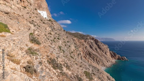 Panorama showing the famous Hozoviotissa Monastery standing on a rock over the Aegean sea in Amorgos island timelapse hyperlapse, Cyclades, Greece. photo