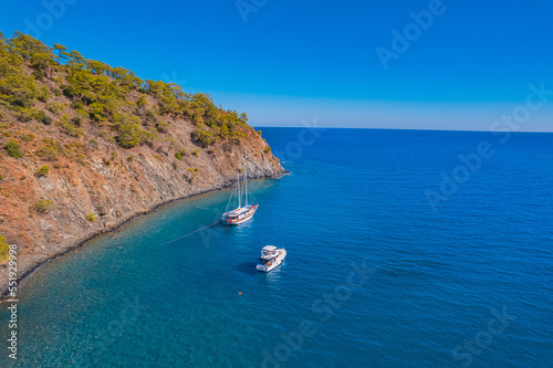 Tropical beach white yacht on blue sea Antalya  Turkey Aerial top view. Concept beautiful travel summer landscape