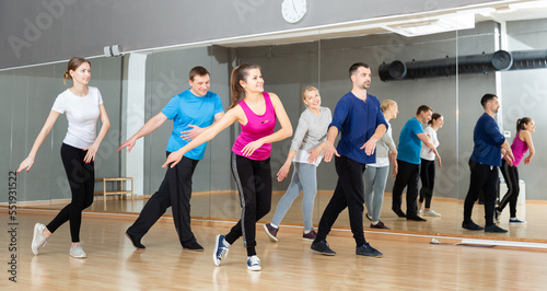 Dance class for adult people  positive young and mature men and women training in dance studio