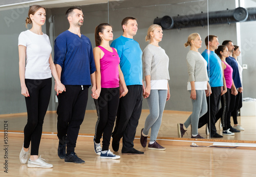 Group of adult people practicing celtic dances in dance class