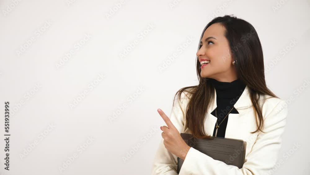 Young brunette elegant woman pointing her index finger to the side, isolated on white background. High quality 4k footage Young brunette elegant woman pointing her index finger to the side, isolated on white background. High quality 4k footage
