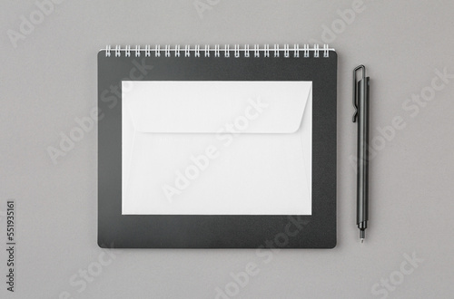 Notepad with pen and envelope.