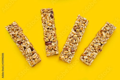 Peanuts butter chocolate bars on yellow background.