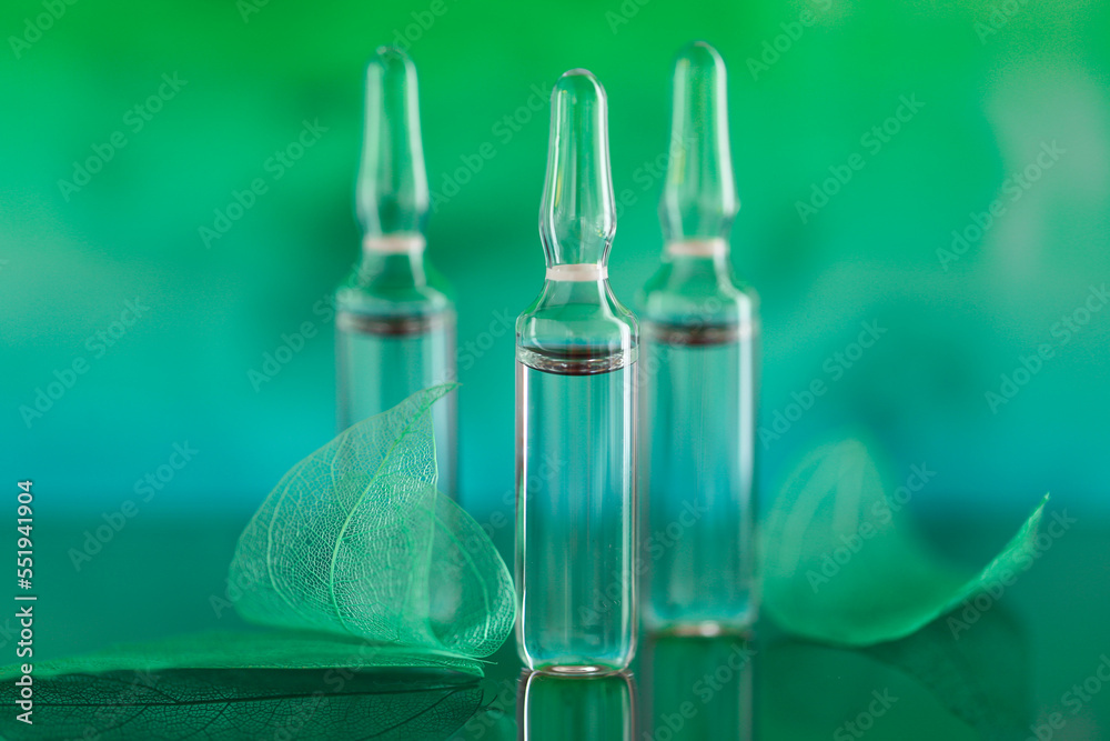 ampoules set and green skeletonized leaves on a turquoise blurred  background.Mesotherapy and dermabrasion serum in ampoules.Hyaluronic acid  Stock Photo | Adobe Stock