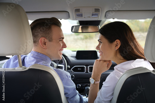 Happy young couple travelling together by car