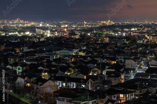 Aerial view of sprawling residential neighborhood near city at night