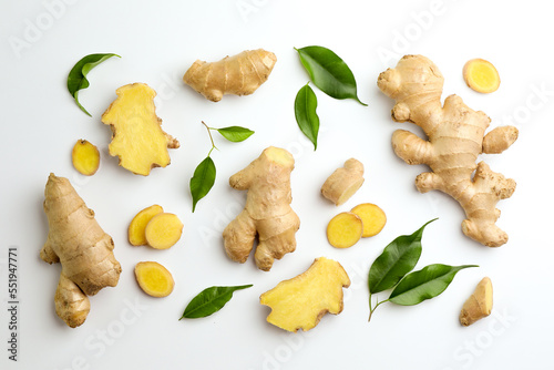 Fresh ginger with green leaves on white background, flat lay