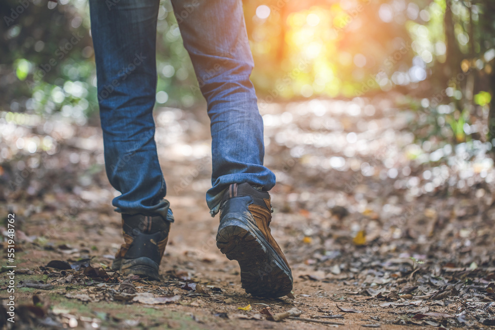 Traveler feet hiking in forest trail Traveler feet hiking in forest trail
